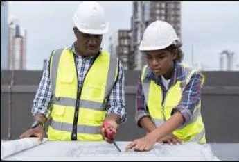 Engineers reviewing construction drawings together